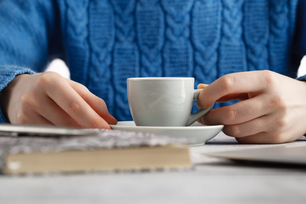 girl drink espresso coffe from small cup